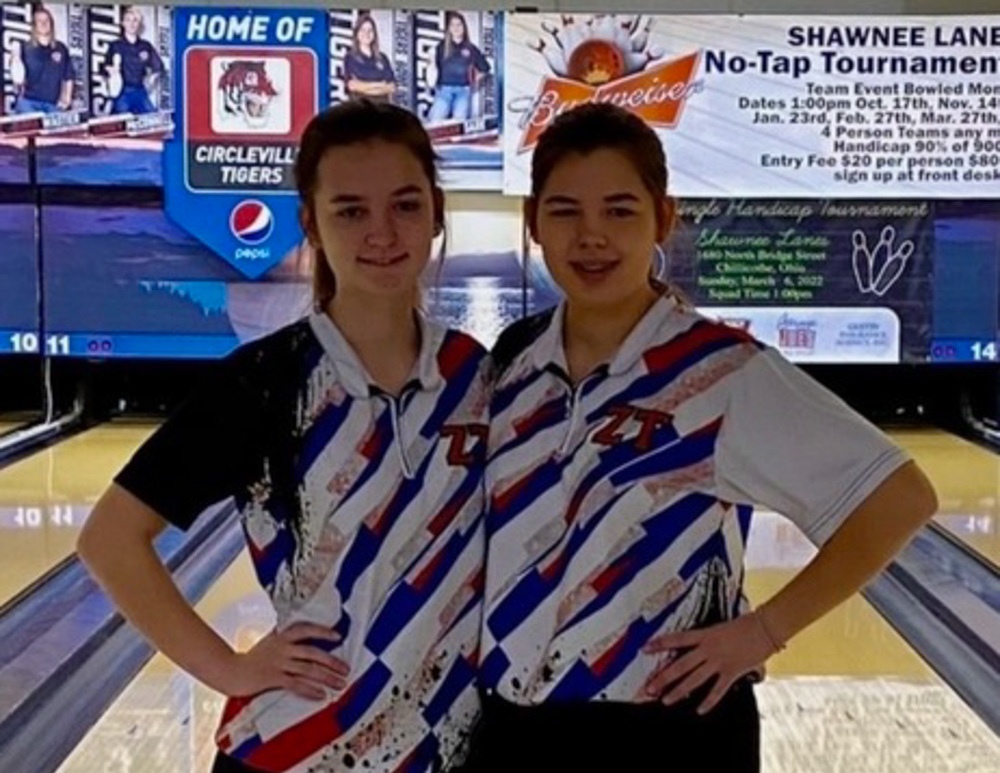 Sisters Nikki and Kaitlyn pose for a photo during a bowling meet. 