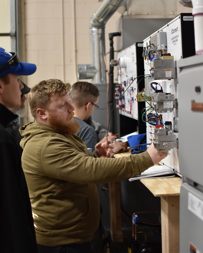 Adult Education HVAC students work in the lab.