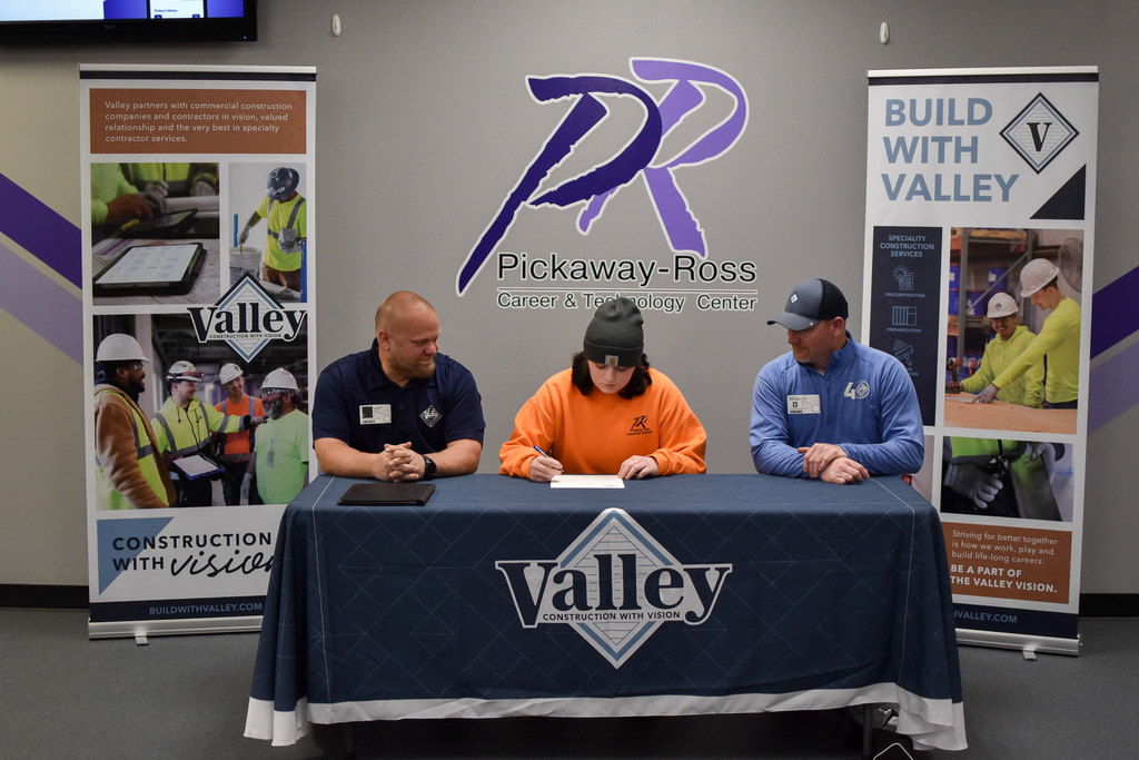 Addison seated between both Valley representatives signing her intent for employment!